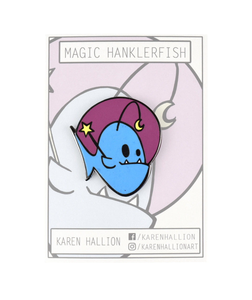 A magic Hanklerfish pin on a grey backing card. The pin is a purple circle with a blue hanklerfish inside holding a baton with a star. From Karen Hallion.