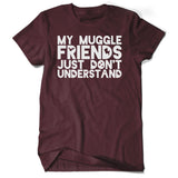 A dark red shirt with “My Muggle Friends Just Don’t Understand” in white sans serif font. Dark red silhouettes of lightning bolts, snitch, stars, and Deathly Hallows logo are in negative space of some letters - from Lauren Fairweather