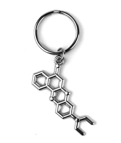 A silver keychain from NileRed with a metal molecule hanging from the ring.