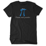 A black t-shirt with a blue pi with a small black smile and two white oval eyes with black irises on the top of the pi drawing with “Pause and ponder.” written underneath in a white serift font in the center of the shirt - from 3Blue1Brown.