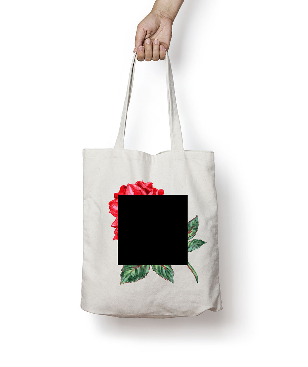 A white tote bag with a red rose with a green stem and leaves covered by a black square - from The Art Assignment
