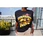 A girl modeling a blue shirt with “Confident & Kind” in half yellow and half orange organic fond. The words are surrounded by various flowers and stars - from Sierra Schultzzie
