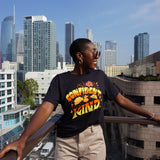 A girl modeling a blue shirt with “Confident & Kind” in half yellow and half orange organic fond. The words are surrounded by various flowers and stars - from Sierra Schultzzie