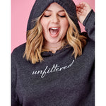 A woman modeling a dark gray crop top hoodie with “unfiltered” in white cursive font across the chest - from Sierra Schultzzie
