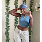 A person taking a mirror selfie, smiling, wearing a blue knit beanie that reads "Chi Kappa". From Sierra Schultzzie.