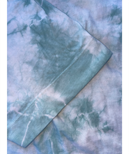 A close up of the blue tie-dye crop top from Sierra Schultzzie, showing the sleeve.