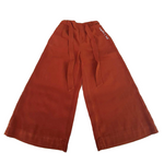 Copper colored pants with a copper colored belt untied and strung along the legs. “Confident & Kind” is in white curisve font along the lefthand pocket - from Sierra Schultzzie