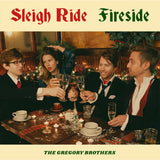 An album cover featuring four people posed in suits and a dress, sitting around a festive table, clinking glasses. On the cover it reads "Sleigh Ride Fireside; The Gregory Brothers". 