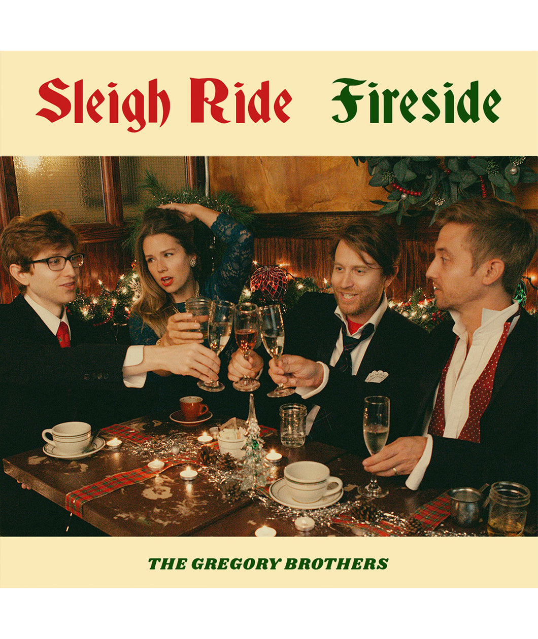 An album cover featuring four people posed in suits and a dress, sitting around a festive table, clinking glasses. On the cover it reads 