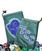 Two views (front and back) of a teal cloth dice bag with a drawstring closure. On one side of the bag is the blue text "TCC" in a block collegiate font. On the other side of the bag is an illustration of a crest -- a dragon's head peering at the pages of an open book. A pile of colorful dice (not included) sit below the bag.