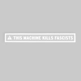 Long rectangular sticker with white border surrounding a white triangle with an exclamation point in the center of it followed by “This Machine Kills Fascists” in white, sans serif font - from John Green