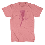 Red shirt with a dark red silhouette of a thistle weed in the center of the shirt. “Hands off” is written on the top of the thistle weed in red sans serif font - from Tyler Thrasher
