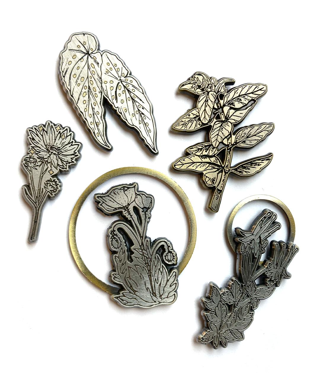 A collection of gold and silver botanical pins from Tyler Thrasher.