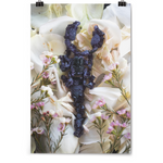 Vetical print of a scorpion with black crystals covering the entire scorpion. The scorpion is laying on a bed of white flowers with smaller pink flowers on their stem surrounding the scorpion - from Tyler Thrasher