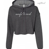 A dark gray crop top hoodie with “unfiltered” in white cursive font across the chest - from Sierra Schultzzie