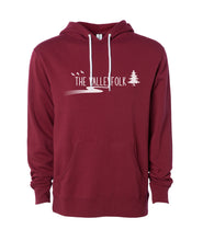 A red hoodie with white drawstrings and in the center, “The Valleyfolk” is written in white sans serif font with three white silhouetted birds to the top left, a white silhouetted tree at the right, and a white gradient sillhouetted river below - from the Valleyfolk
