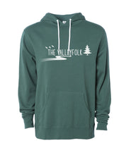 A green hoodie with white drawstrings and in the center, “The Valleyfolk” is written in white sans serif font with three white silhouetted birds to the top left, a white silhouetted tree at the right, and a white gradient sillhouetted river below - from the Valleyfolk