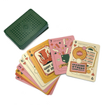 A set of Nerdfighter playing cards. There is a face down stack with a dark green pattern on the card. There is a also a fan of cards laid out in a warm pastel color scheme with different illustrations on them.